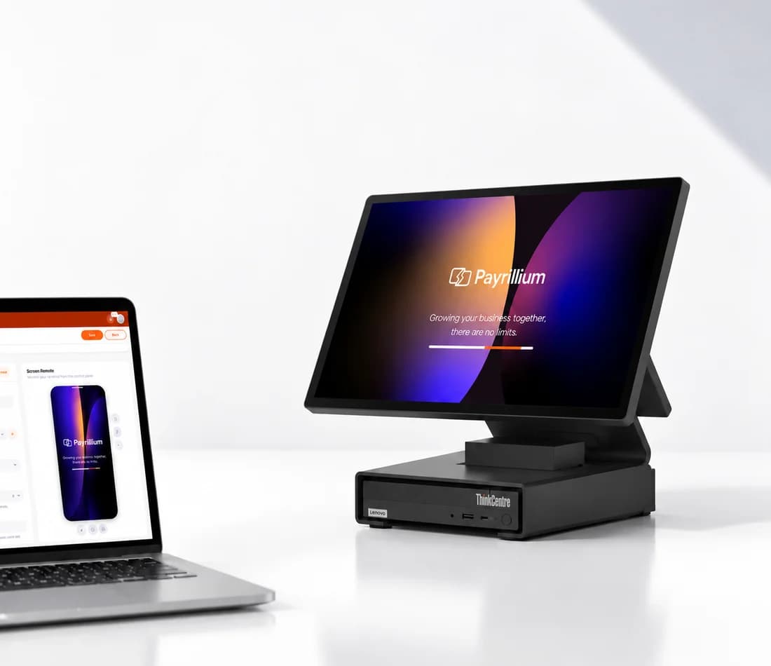 A Payrillium console open on a laptop beside a counter station, mirroring the terminal's screen